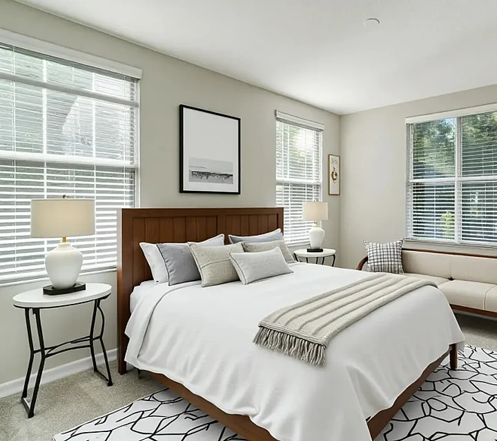 Bright and inviting bedroom interior featuring elegant decor, modern furniture, and ample natural light through large windows.