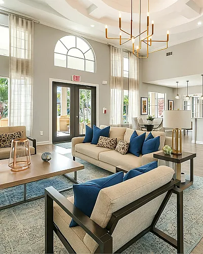 Bright and spacious modern living area with elegant decor, high ceilings, and large windows offering natural light.