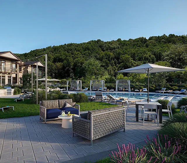 Luxurious outdoor area with stylish seating, charming string lights, and a sparkling pool surrounded by lush greenery, perfect for relaxation and entertainment.
