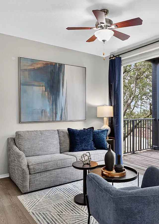 Bright and inviting living room with elegant decor, cozy seating, and a scenic balcony view, perfect for relaxation and entertaining.