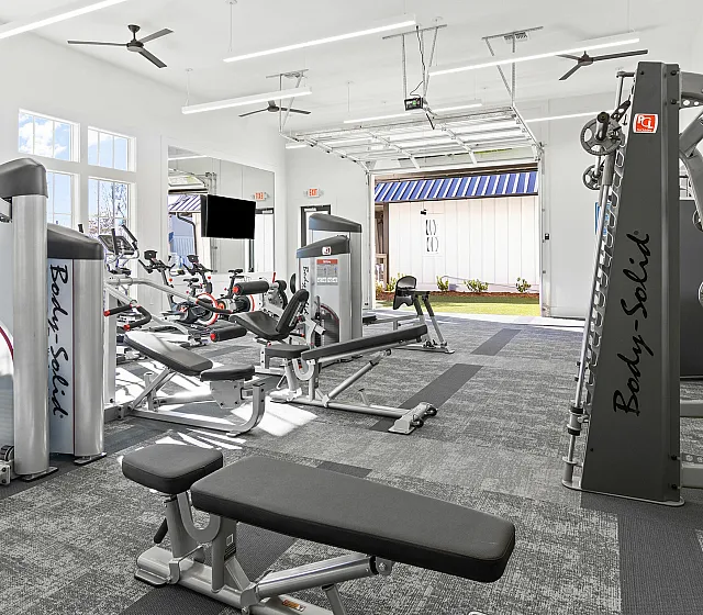Bright and modern fitness center with state-of-the-art equipment and large windows for natural light.