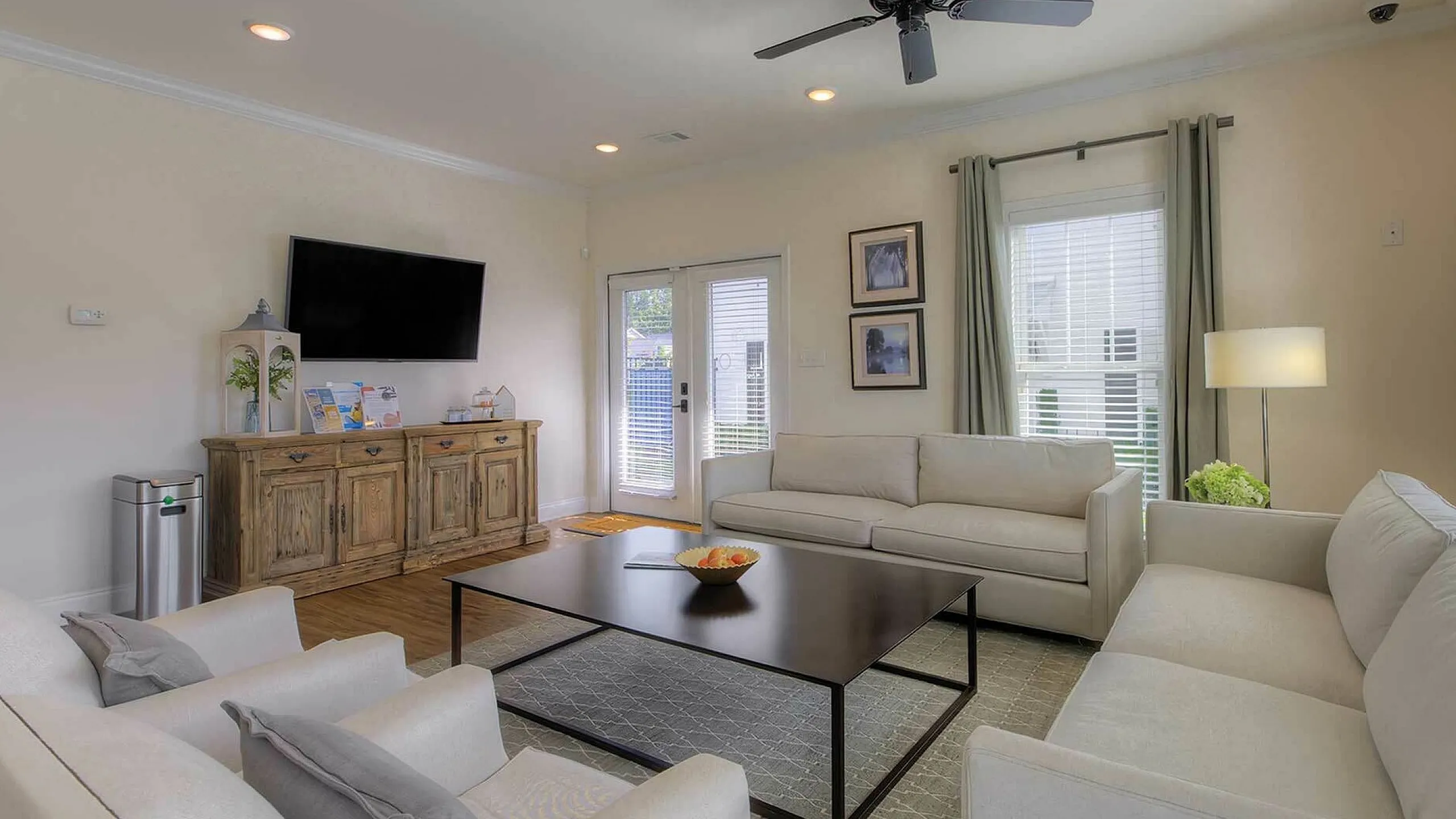 Bright and inviting living room with elegant sofas, modern decor, and large windows, perfect for relaxation and entertainment.