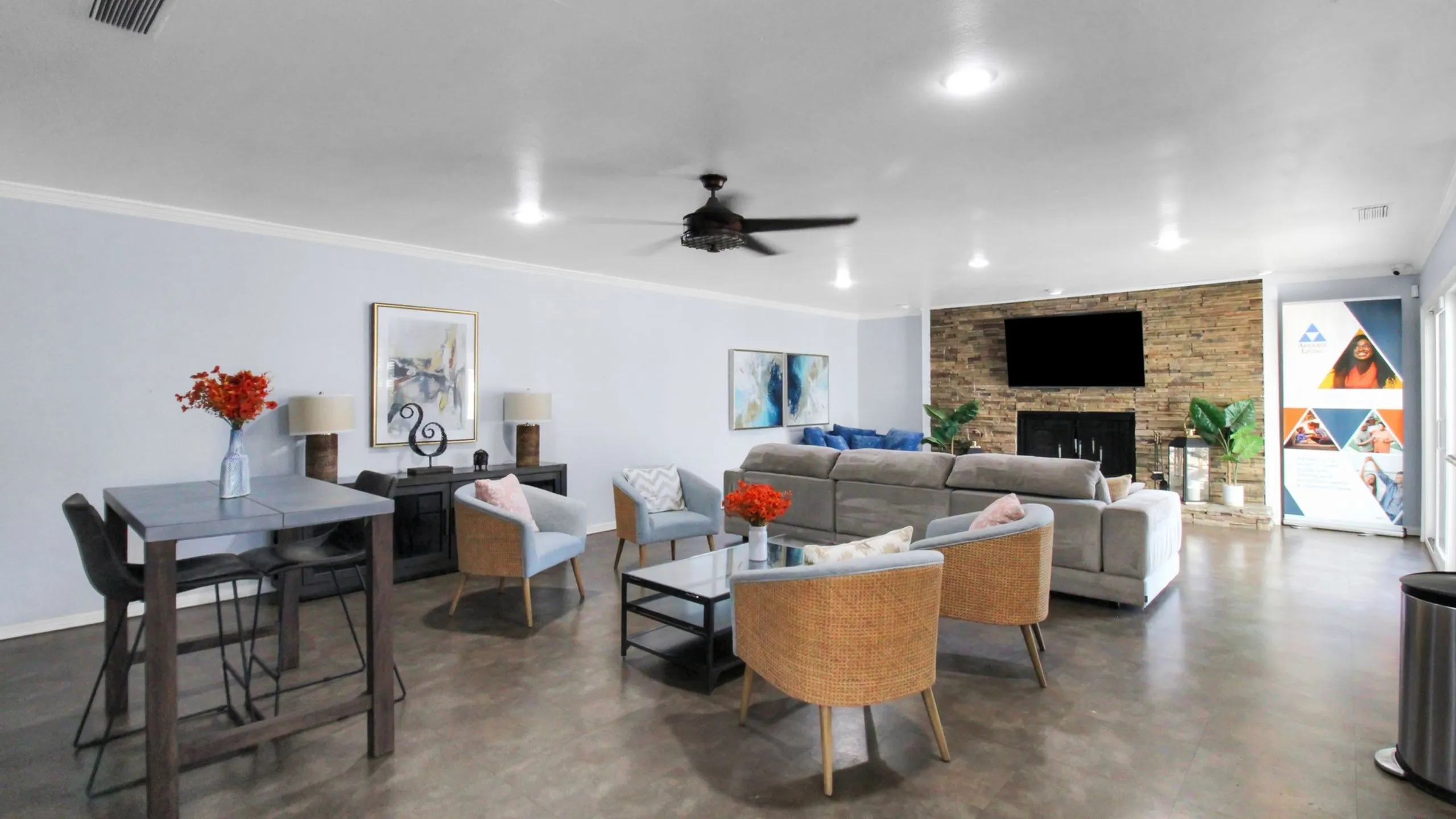 Elegant living room with cozy seating area, modern furniture, vibrant artwork, and a stylish brick fireplace.