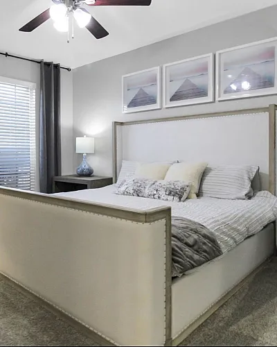 Elegant bedroom with a cozy bed, stylish decor, and soft lighting, offering a serene and inviting ambiance.