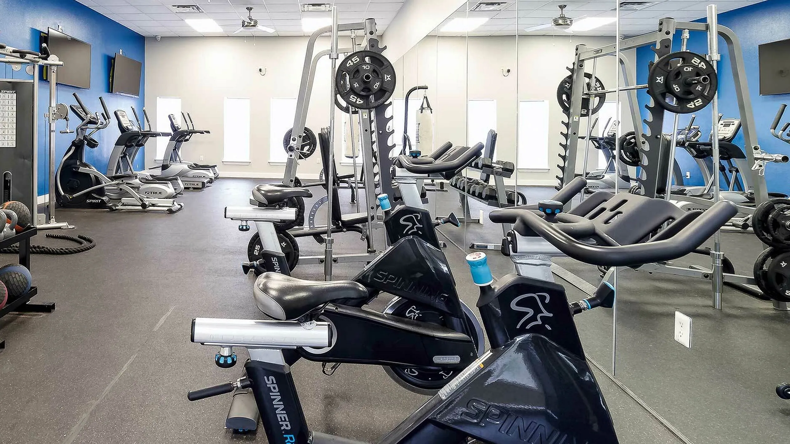 Modern fitness center equipped with state-of-the-art gym equipment, bright lighting, and spacious layout for an enhanced workout experience.