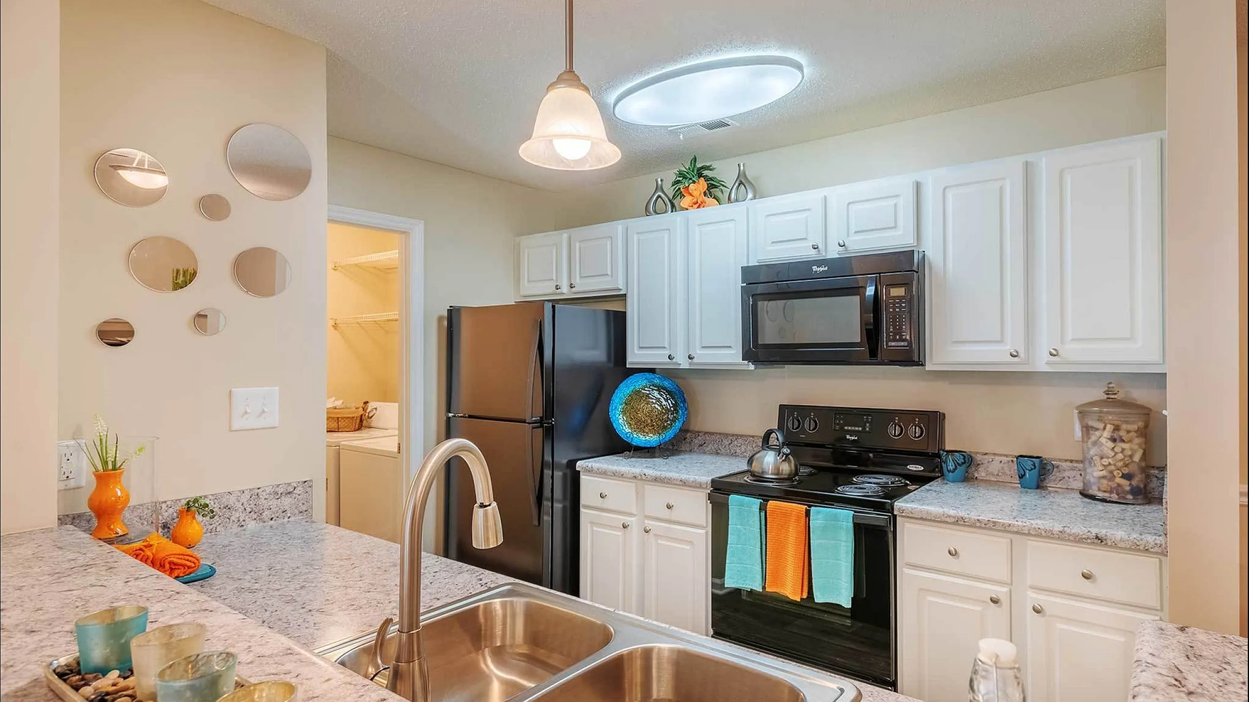 Bright and modern kitchen featuring sleek granite countertops, stainless steel appliances, and elegant cabinetry with stylish decor.