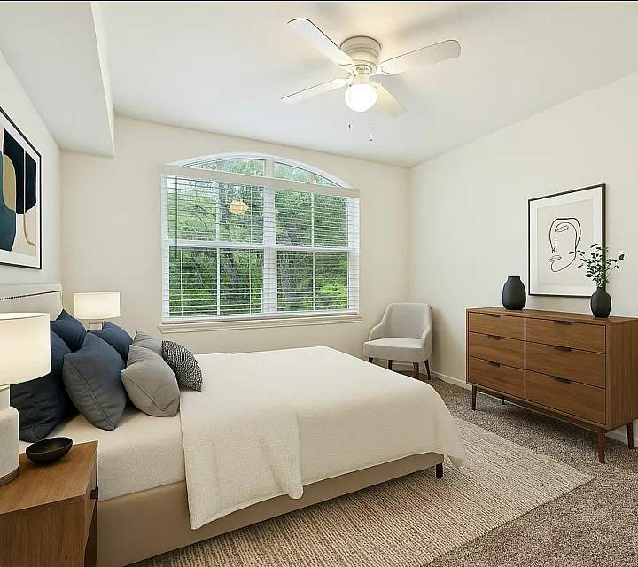 Inviting bedroom with large window, elegant furnishings, and natural lighting.