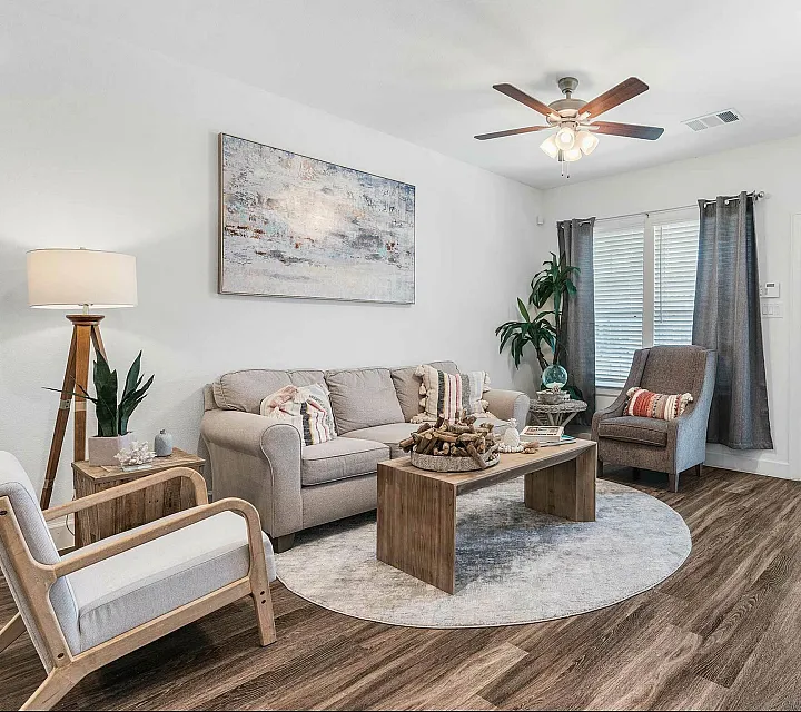 Chic living room featuring modern decor, comfortable seating, and elegant wooden flooring, perfect for relaxation and entertaining guests.