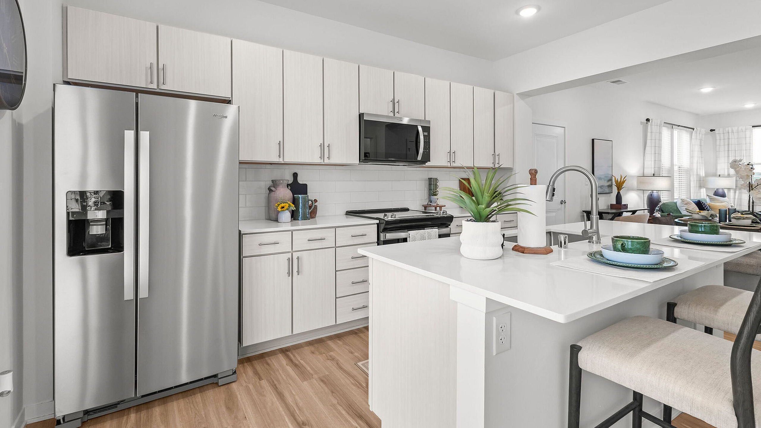 Modern kitchen with sleek stainless steel appliances, white cabinetry, and a spacious island perfect for entertaining.