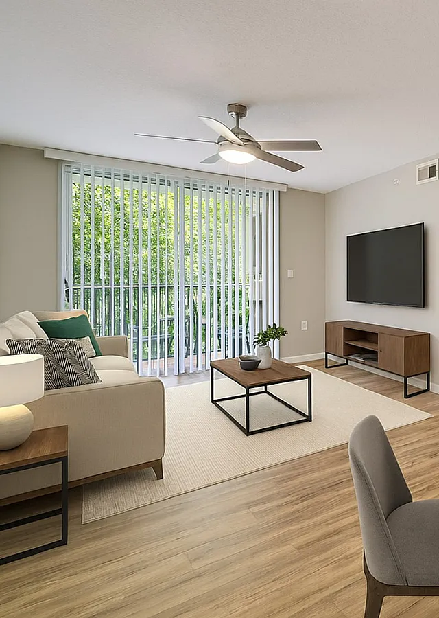 Bright and modern living room with stylish decor, featuring a cozy sofa, sleek TV setup, and elegant dining area on wooden flooring.