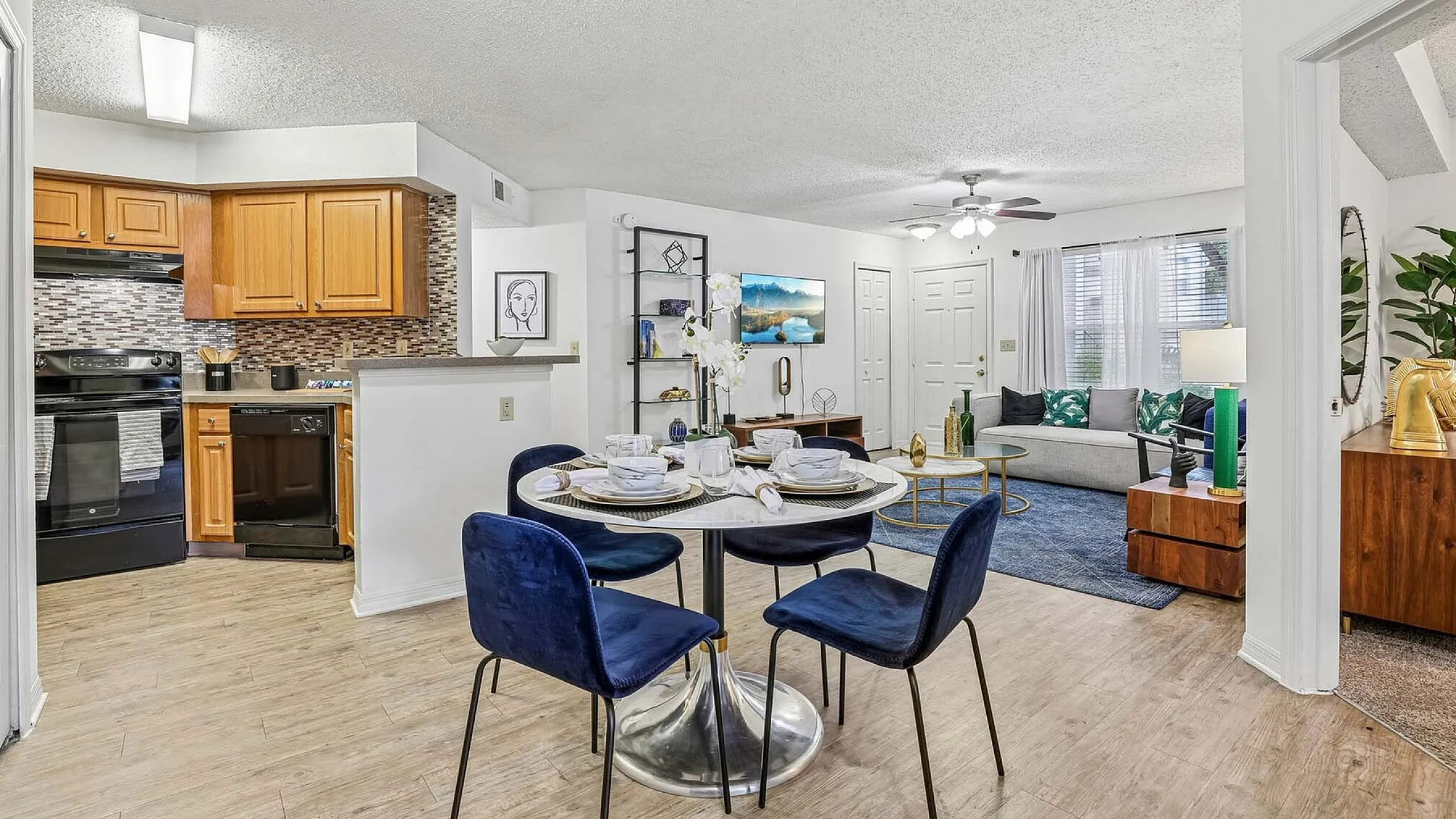 Chic open-plan apartment with a modern kitchen, elegant dining area, and cozy living room perfect for stylish living.