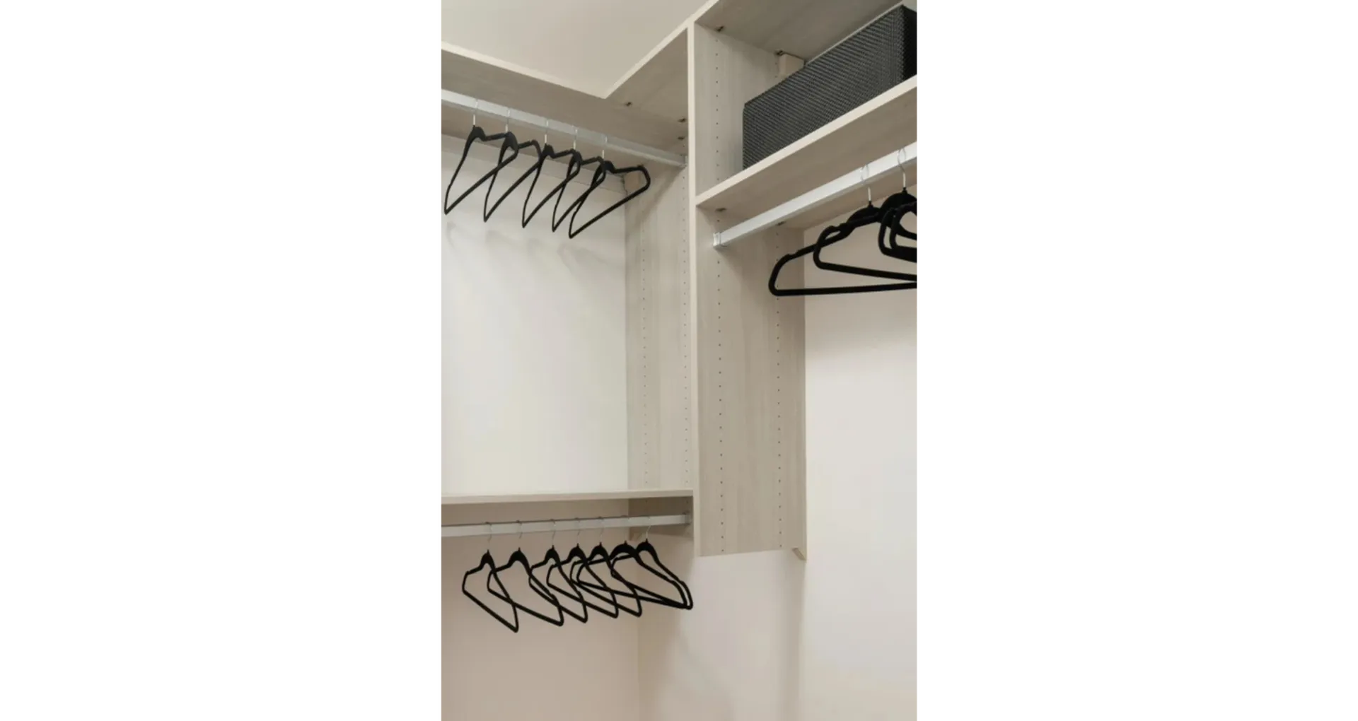 Sleek walk-in closet with modern shelving and ample hanging space, perfect for organized living.