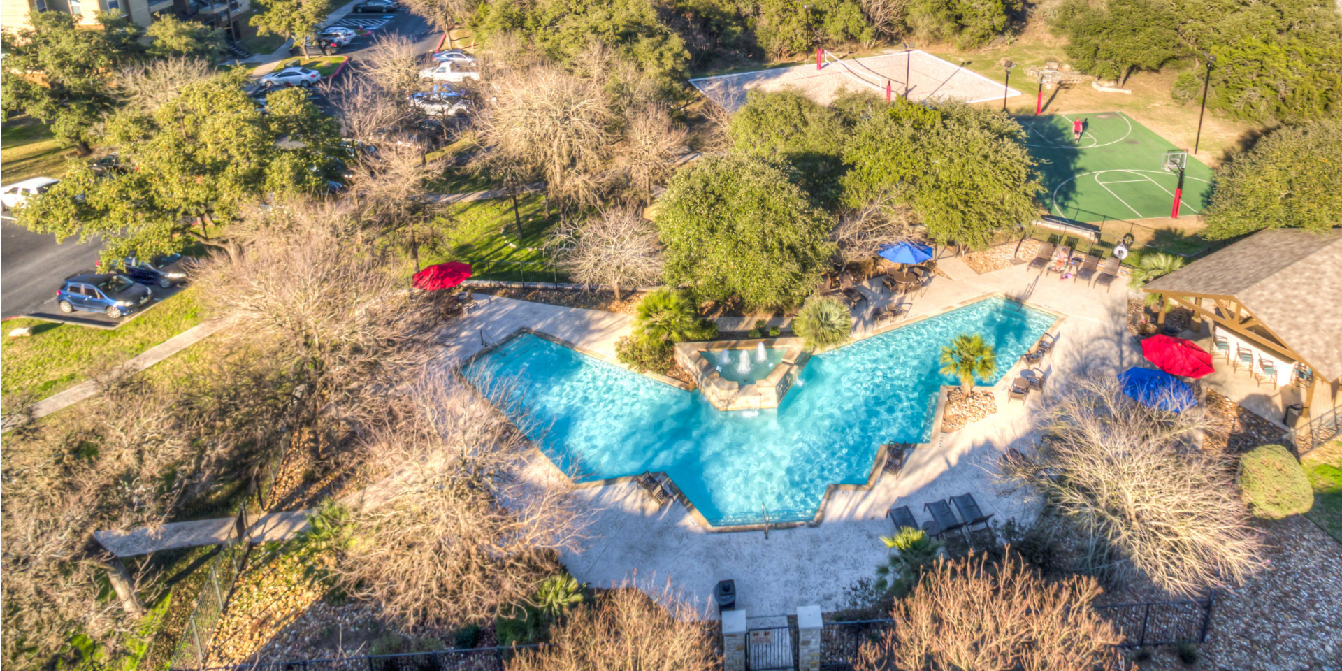 Clubhouse with pool table, kitchen-serving area, comfortable seating | Dakota Ranch Student Apartments | San Marcos, TX