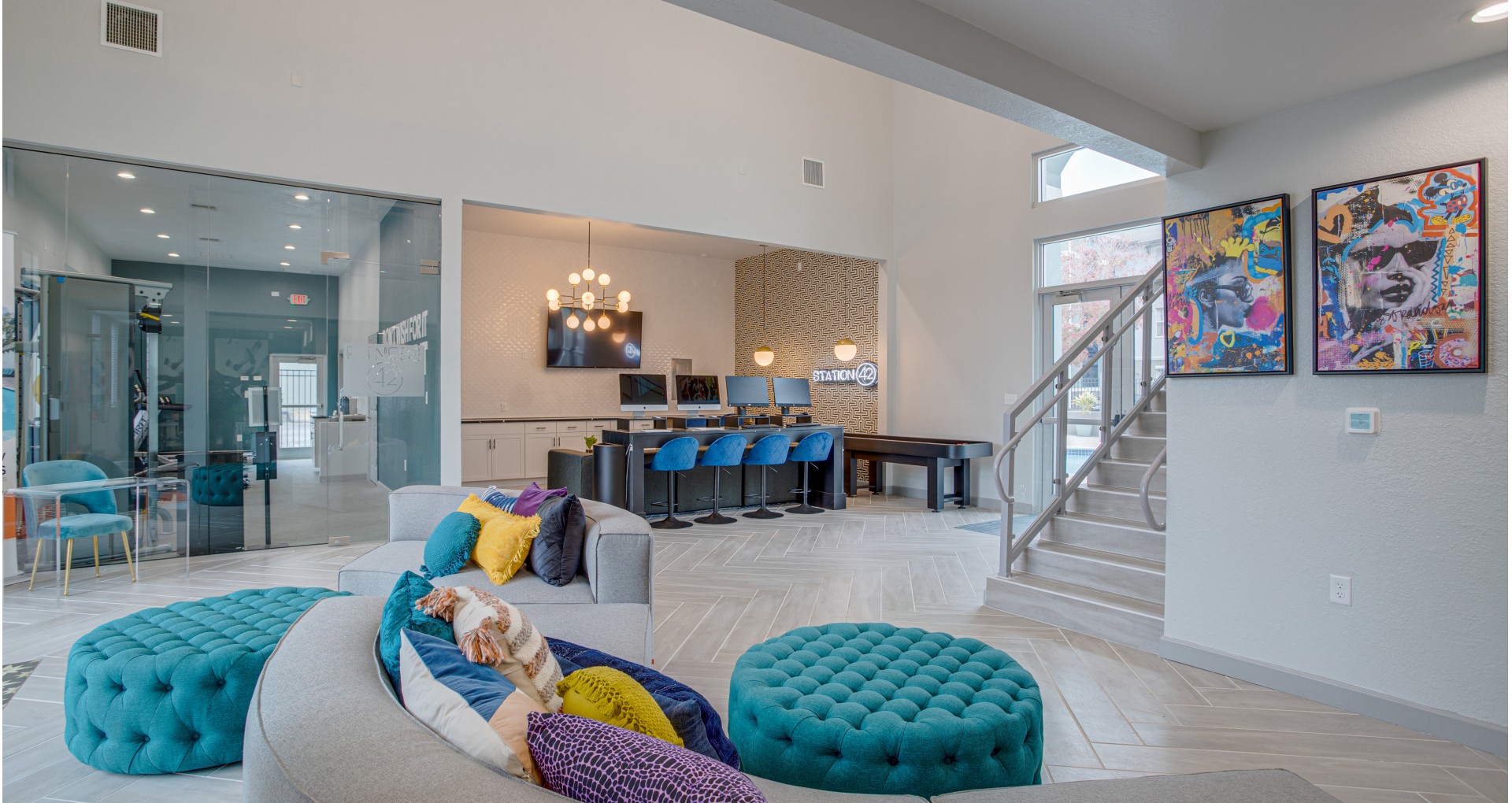 Clubhouse staircase, seating, and computers | Station 42 | Tampa Apartments Near USF