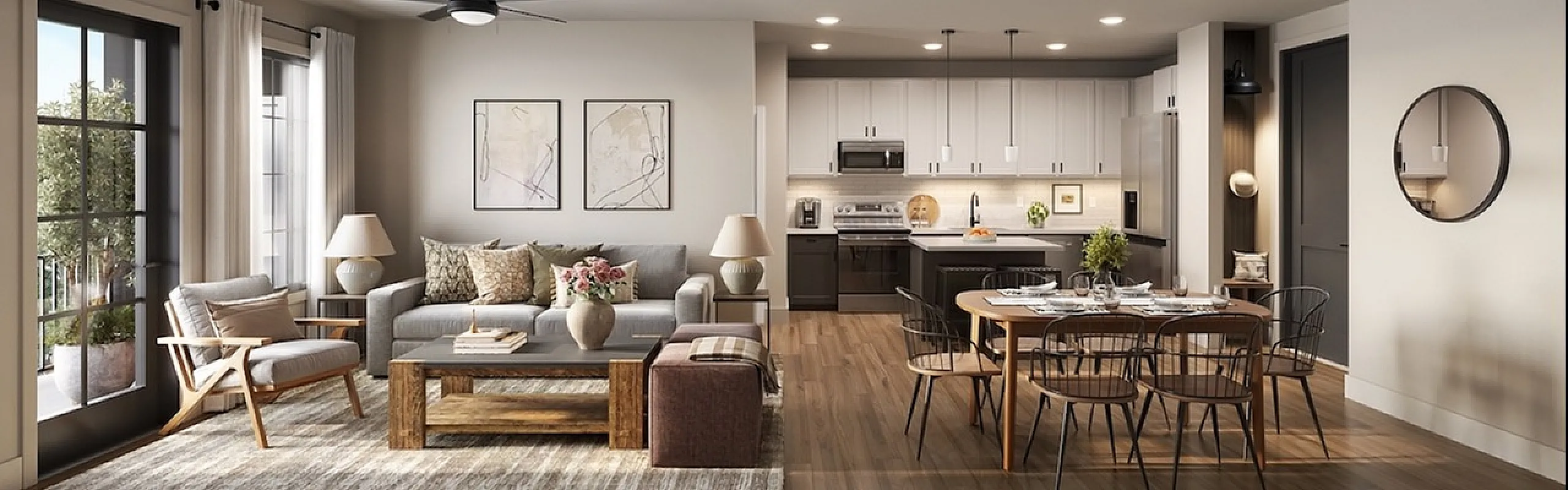 Elegant open-concept living room and kitchen with modern furnishings and natural light.