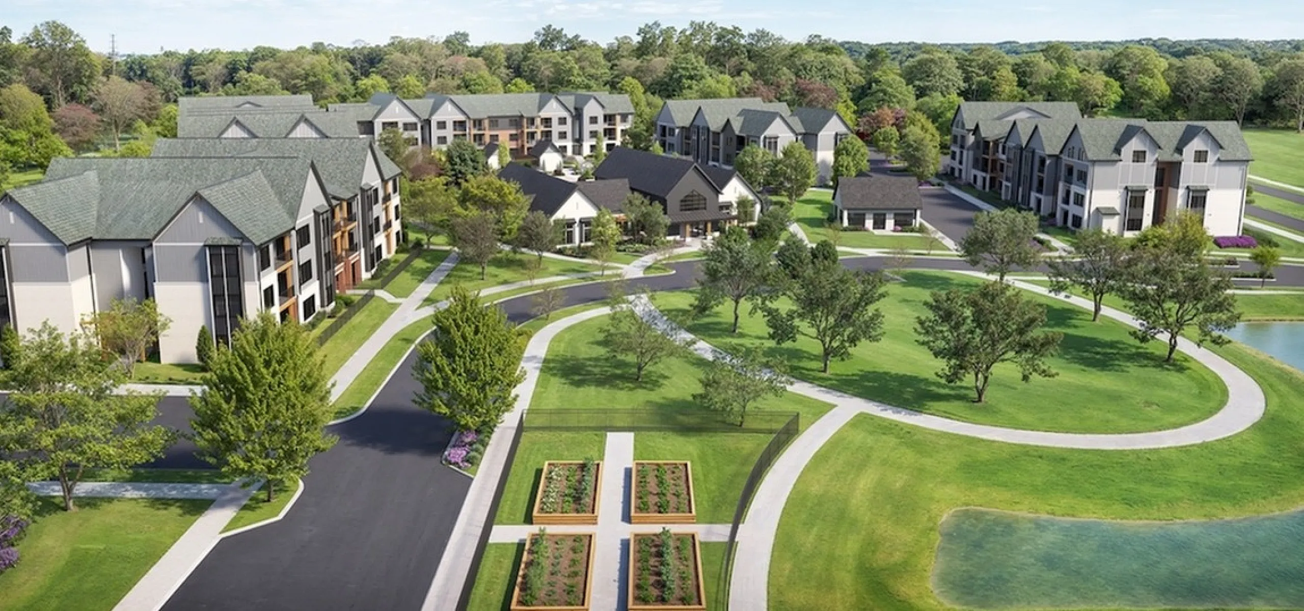 Aerial view of a serene apartment community surrounded by lush greenery and landscaped gardens.