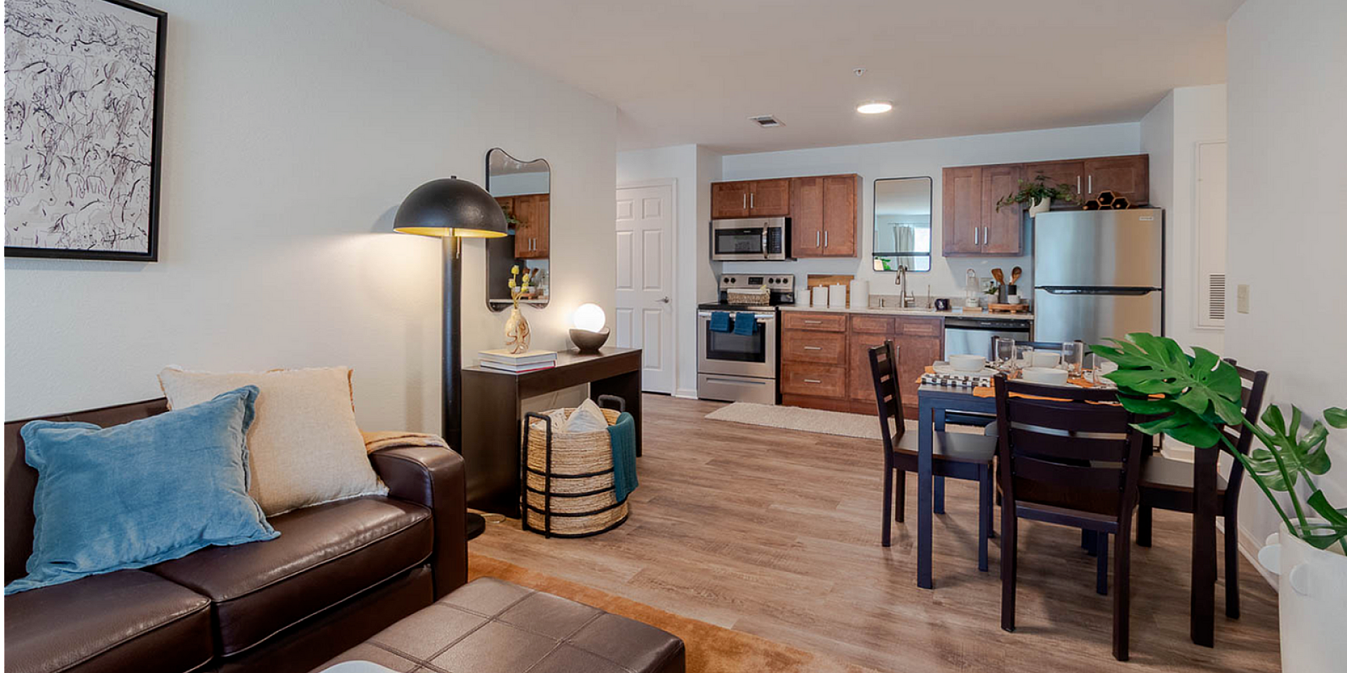 Chic modern apartment with a cozy living area, stylish kitchen, and inviting dining space, perfect for comfortable living.