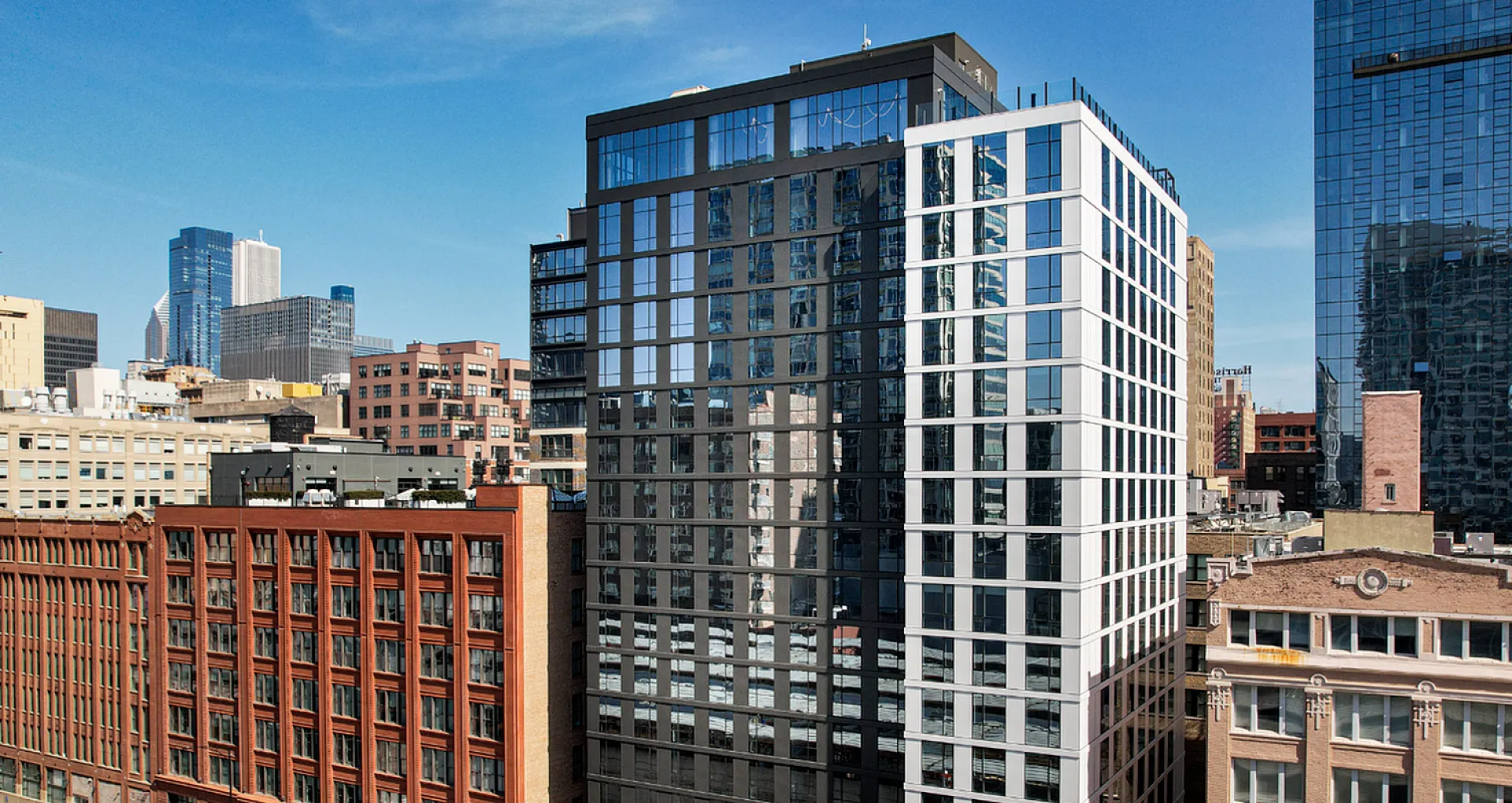 Modern high-rise apartment building in vibrant urban setting, featuring sleek architecture and expansive city views.
