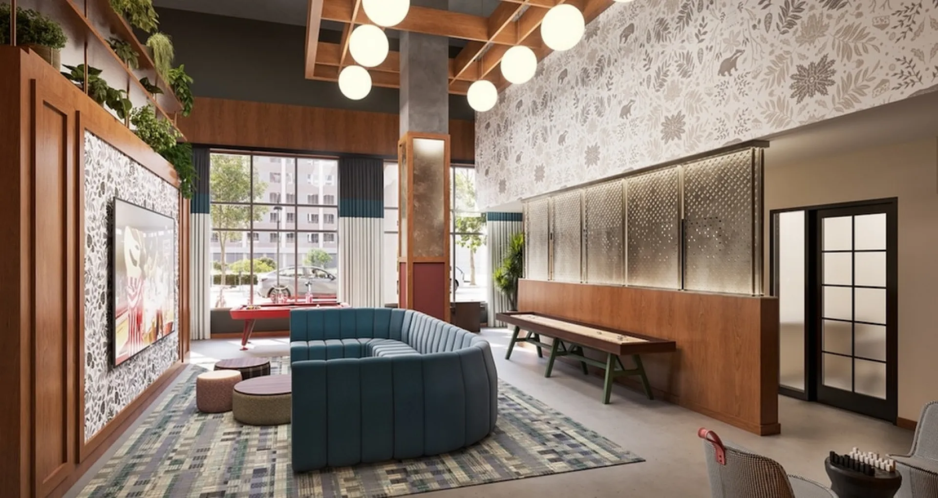 Modern lounge area with vibrant blue sectional sofa, elegant lighting, and stylish decor, creating a welcoming and chic atmosphere.