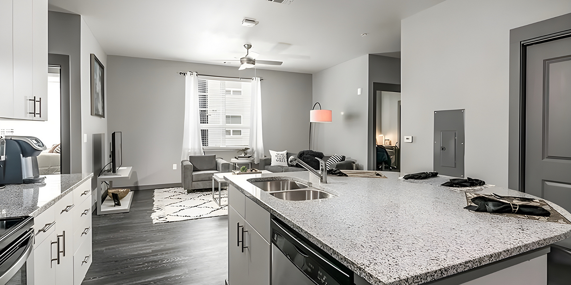 Modern open-plan living space with sleek kitchen island, cozy living area, and stylish decor.