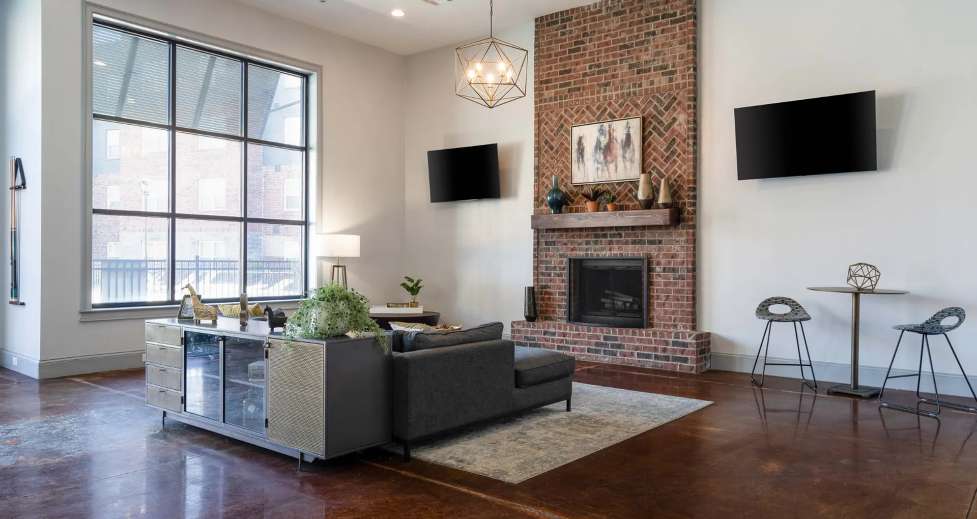 Chic living room with high ceilings, large window, stylish brick fireplace, and modern decor, offering a cozy yet elegant ambiance.