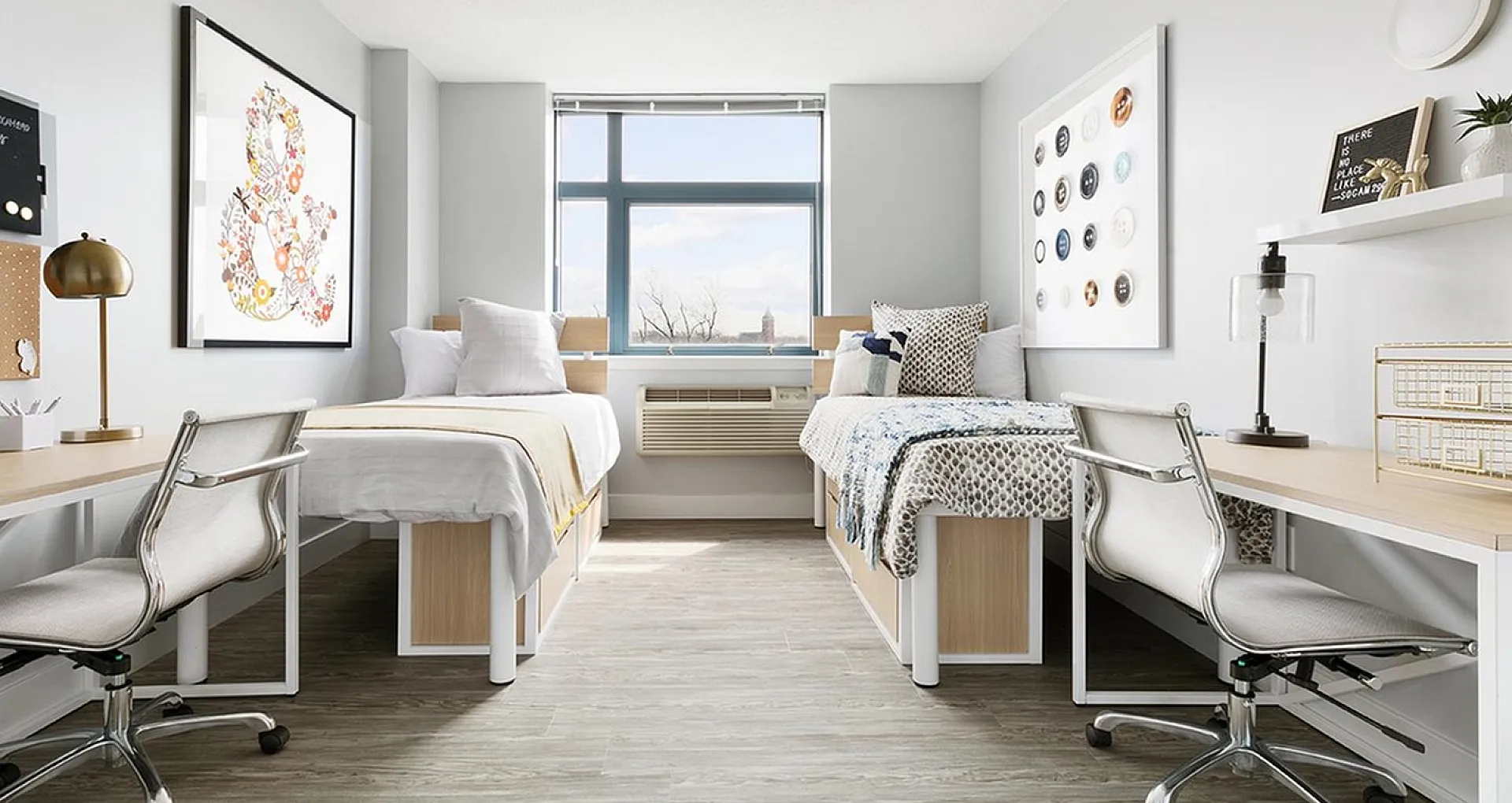 Bright and modern double bedroom with stylish decor, featuring large window, sleek desks, and contemporary artwork.