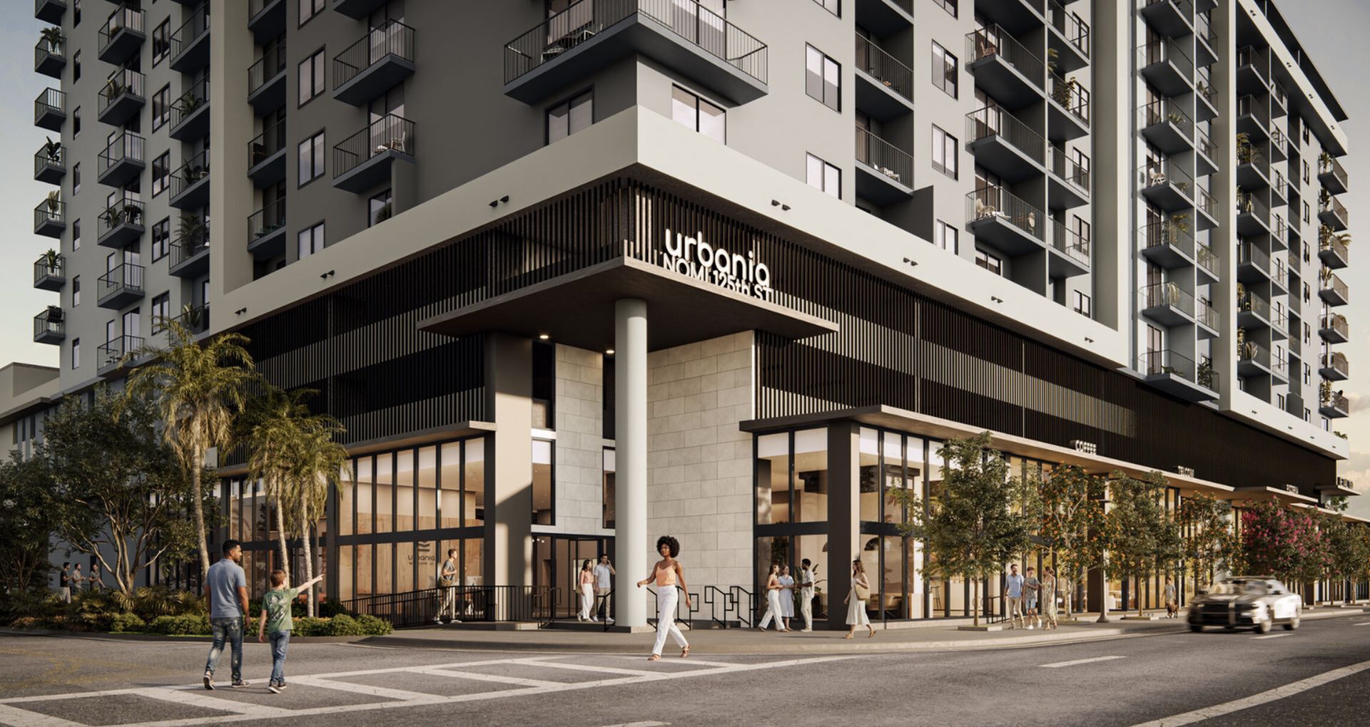 Elegant urban apartment building, Urbania NOM 125th St, featuring modern design with spacious balconies and inviting streetside view, surrounded by lush greenery and vibrant community atmosphere.
