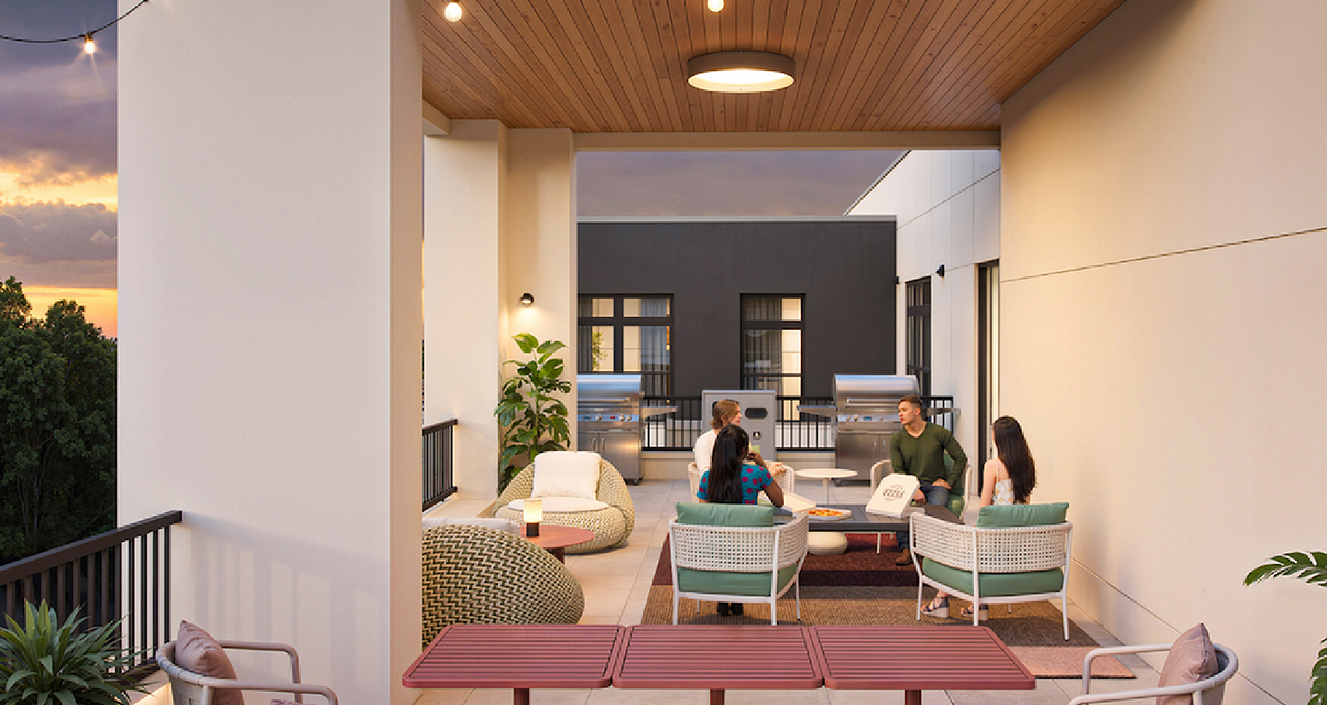 Chic rooftop patio with stylish seating, perfect for social gatherings and relaxation under string lights.