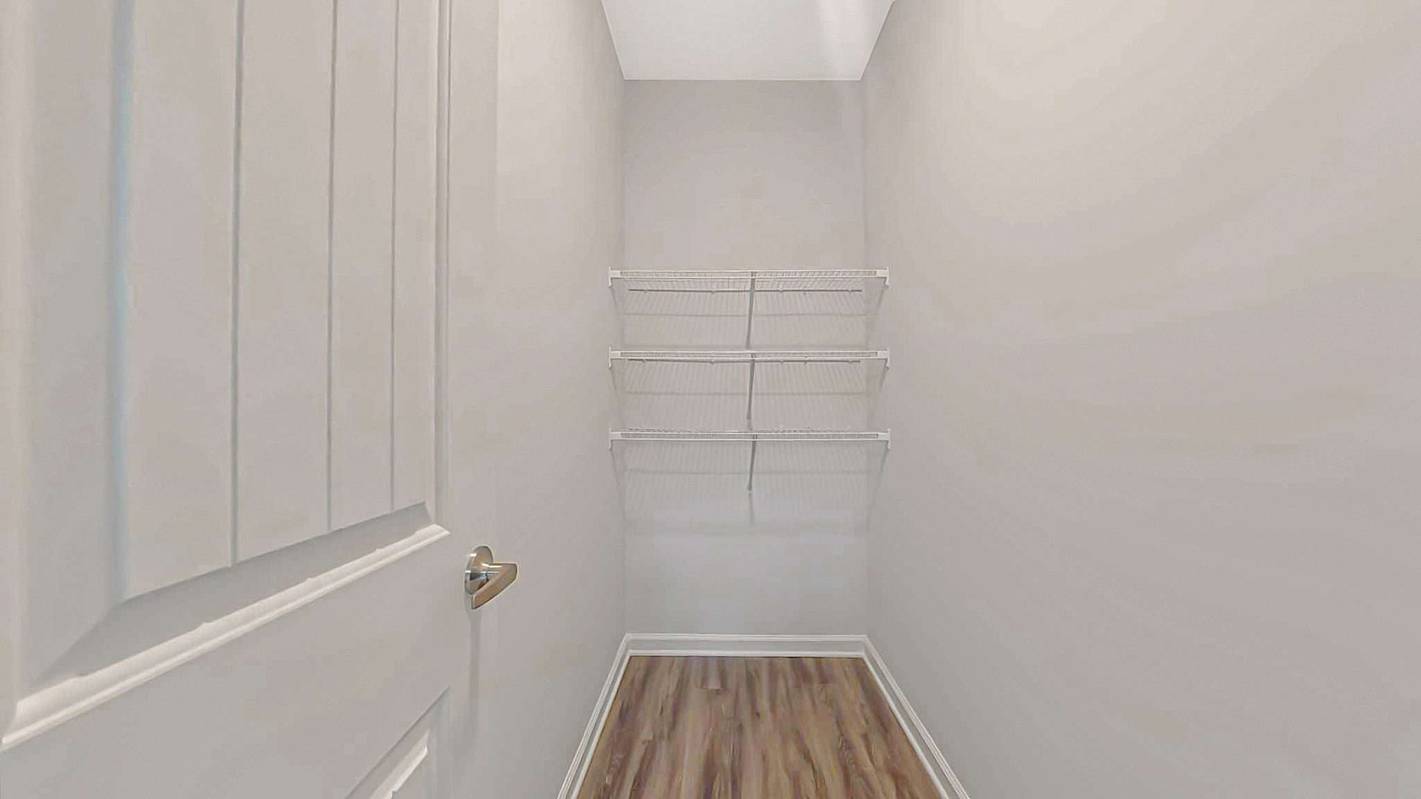 Modern walk-in closet with sleek shelving, perfect for optimizing storage and style.