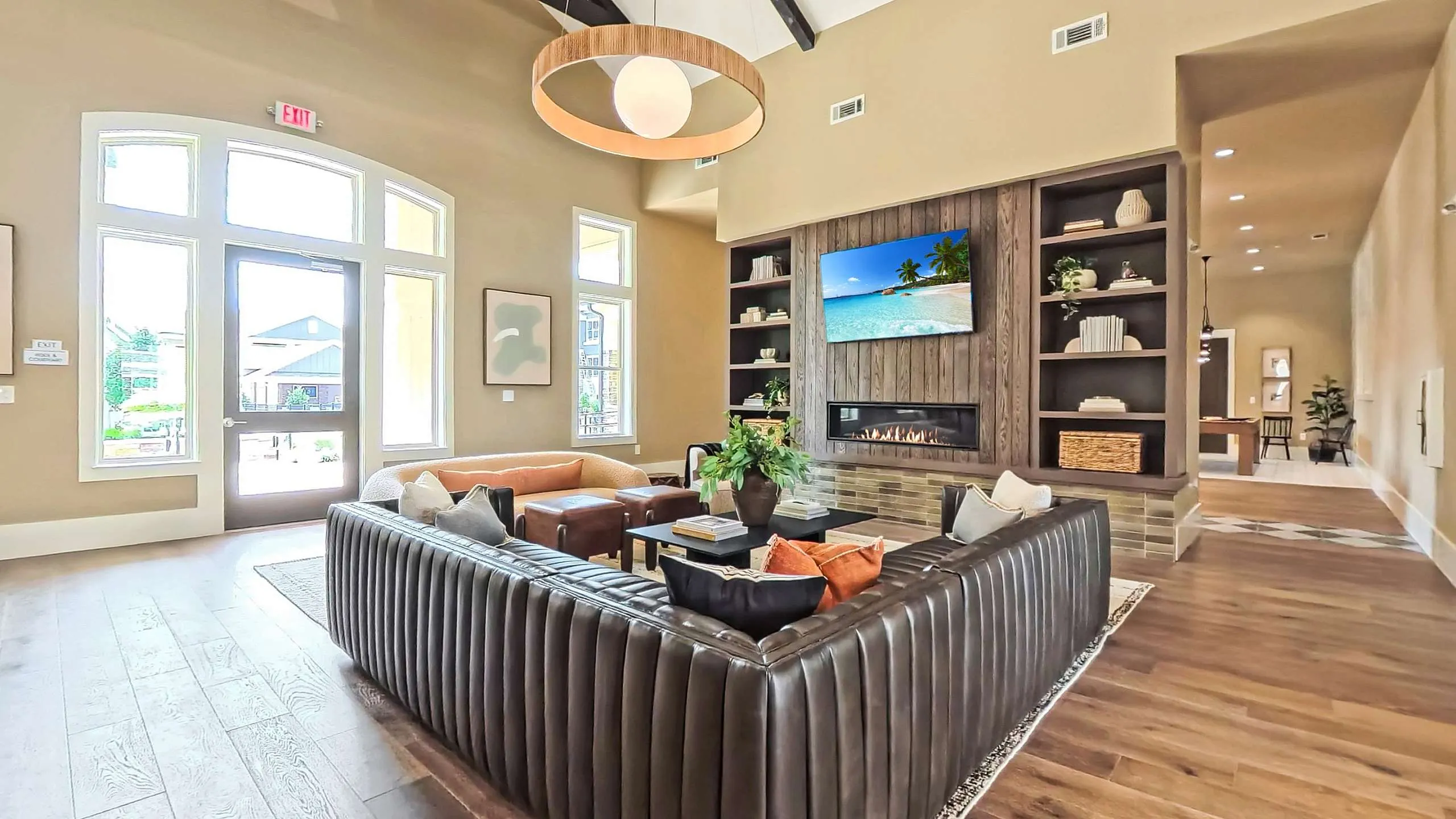 Luxurious living room with a stylish leather sofa, elegant high ceilings, and a modern fireplace, exuding warmth and comfort.