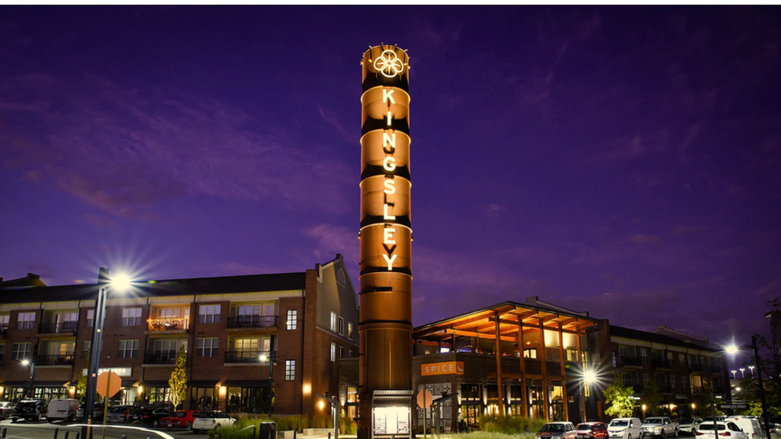 Luxurious apartment community at twilight featuring vibrant lighting, modern architecture, and vibrant lifestyle amenities.