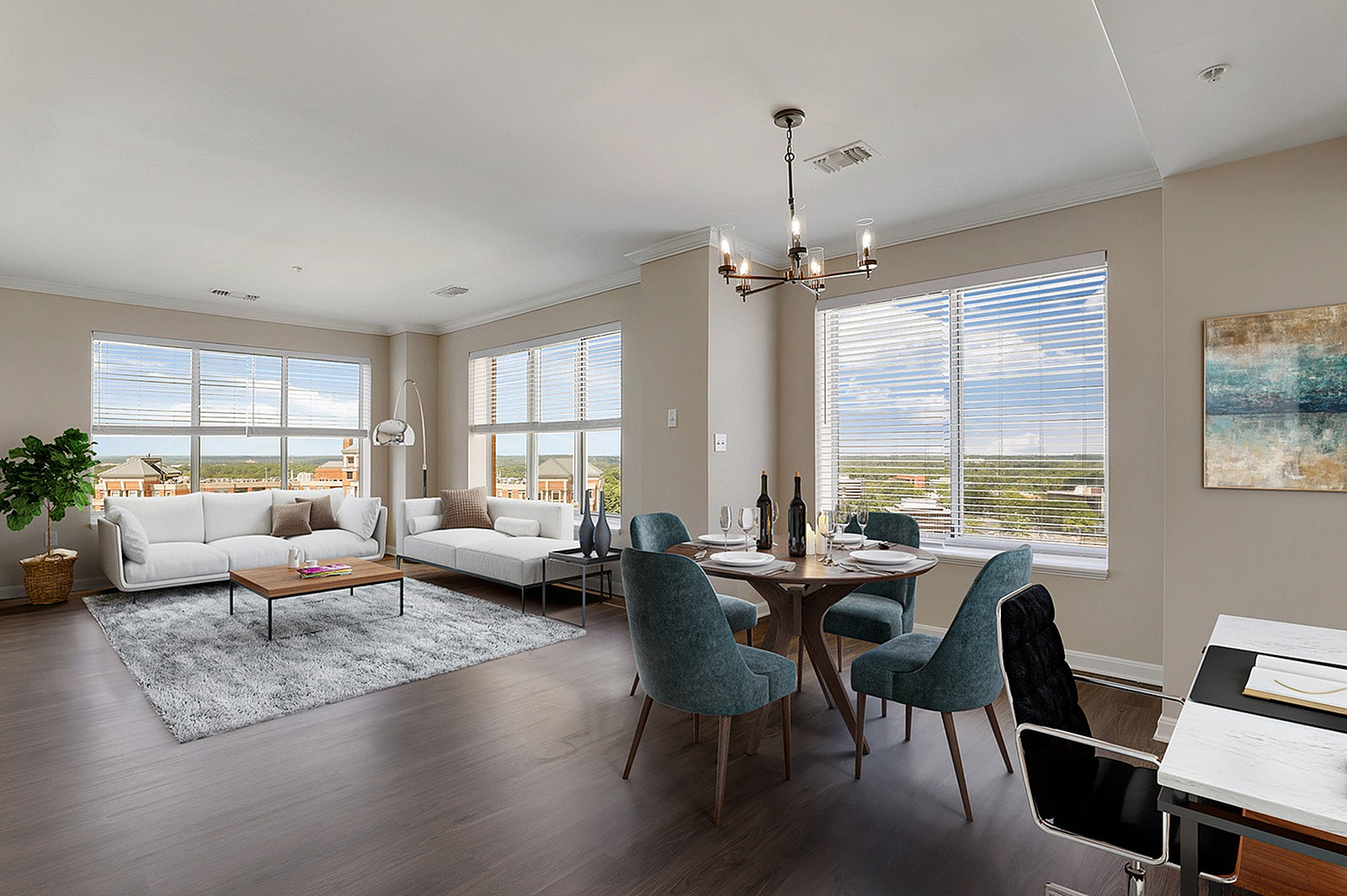 Bright, open-concept living and dining area with large windows, elegant furnishings, and stunning views.