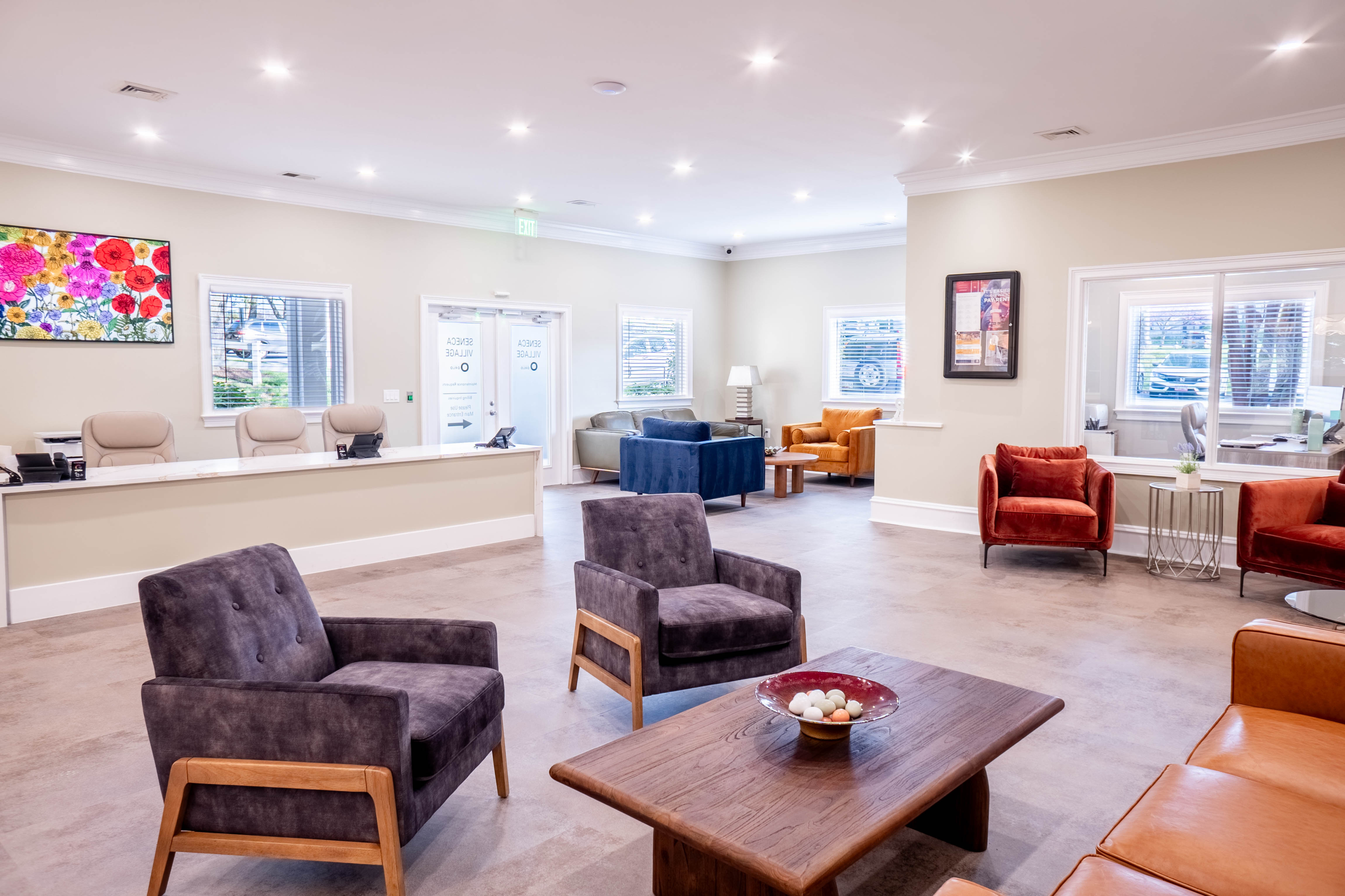 Inviting lobby featuring elegant seating areas with vibrant chairs, stylish decor, and ample natural light for a welcoming atmosphere.