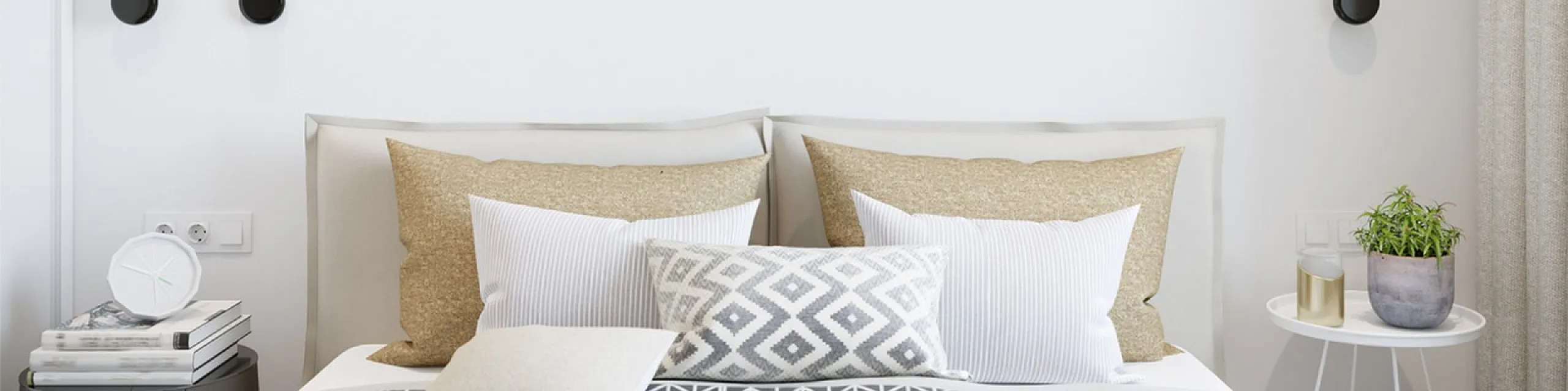 Chic bedroom with neutral tones, modern lighting, and stylish bedding, perfect for a cozy retreat.