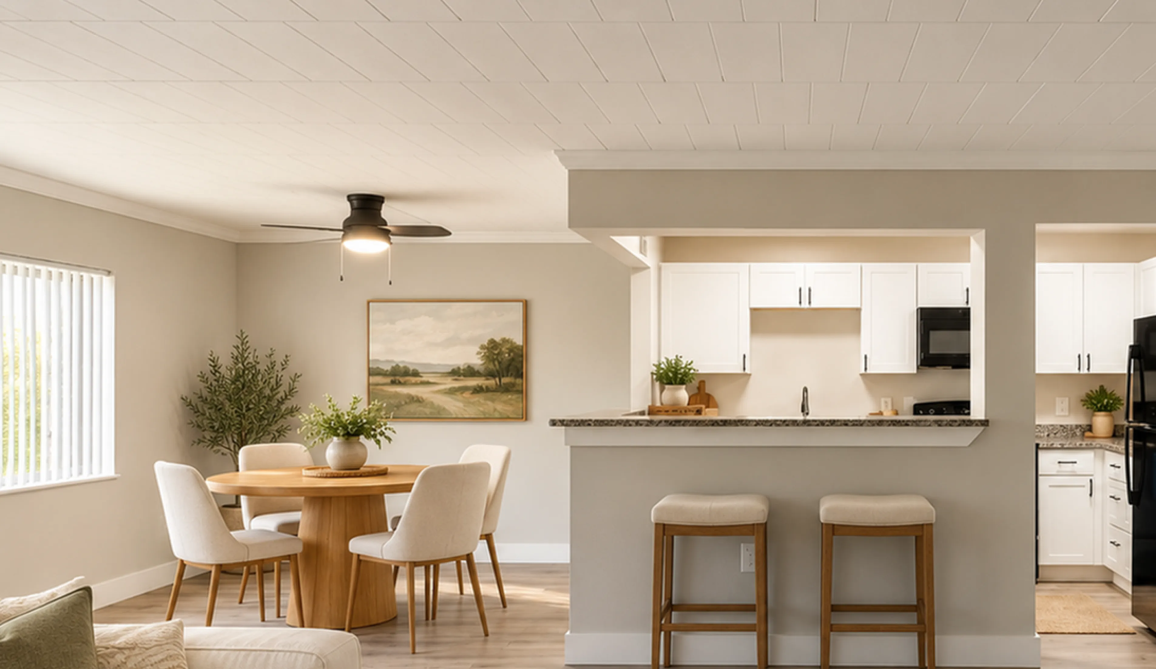Bright and inviting open-concept living space featuring a modern kitchen with bar seating and a cozy dining area.