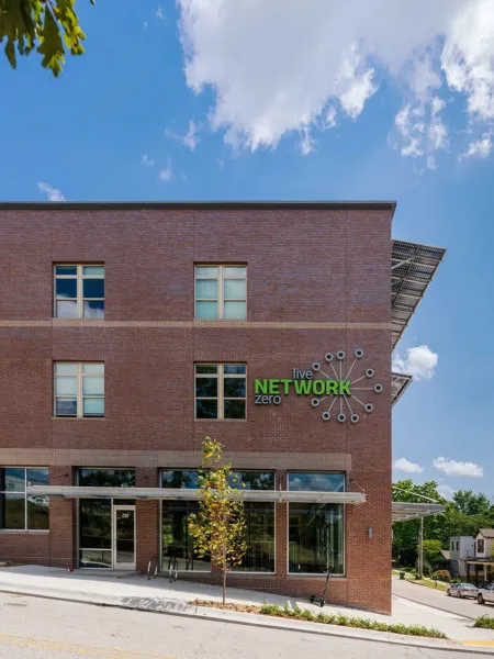 Three story brick Network Building with solar panels on the awnings