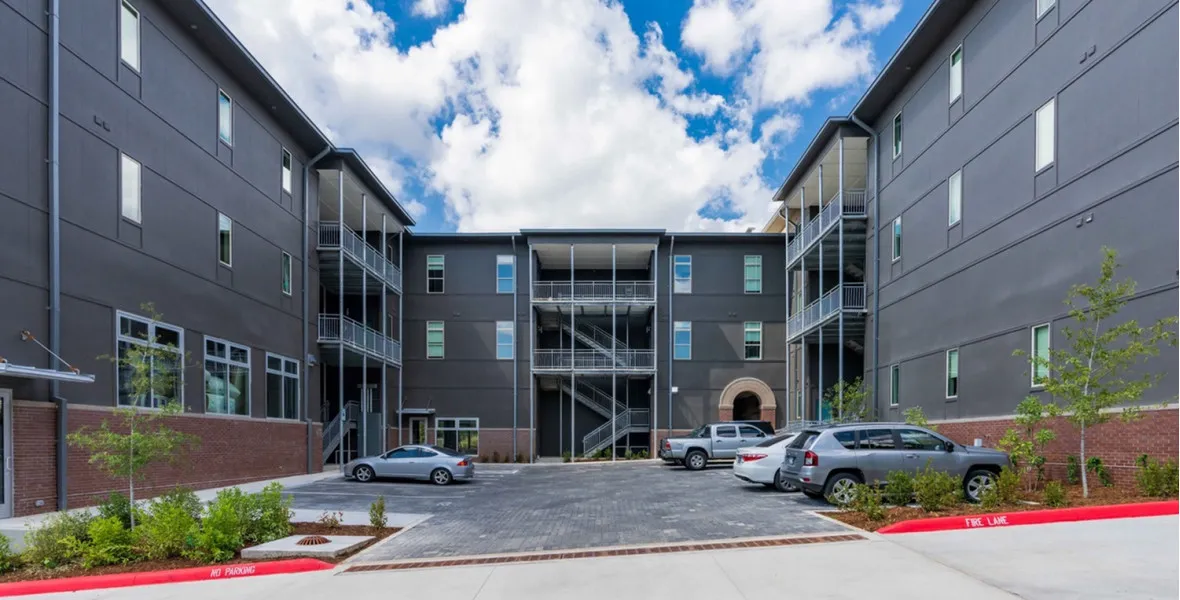 A brick-paved courtyard within the wings of a three story buliding