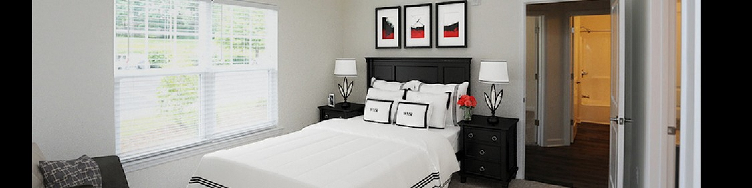 Bright and cozy bedroom with modern decor, featuring a large window, plush bedding, and a stylish ceiling fan.