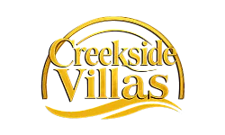 Elegant Creekside Villas logo featuring sophisticated golden typography and artistic swooshes.