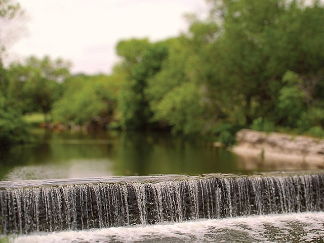 Serene natural waterfall nestled in lush greenery, offering a tranquil escape and picturesque views.