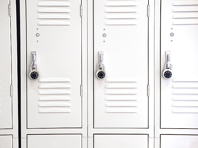 Sleek white metal lockers with secure combination locks, perfect for organized gym or school storage.