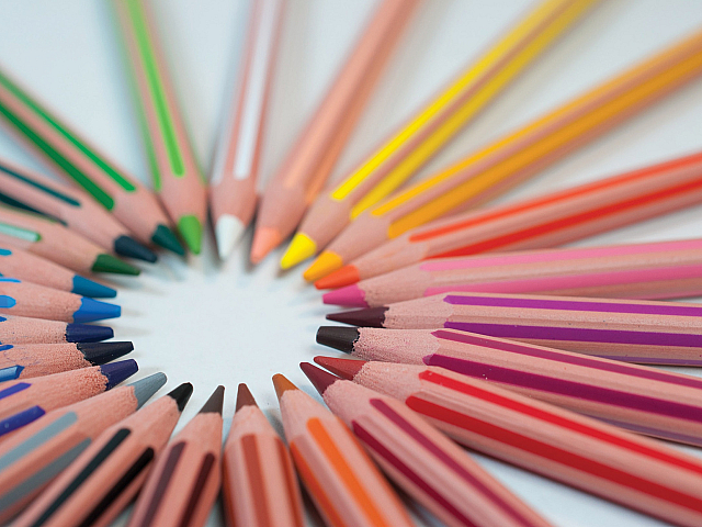Vibrant array of colored pencils arranged in a circular pattern, showcasing a spectrum of hues for creative inspiration.