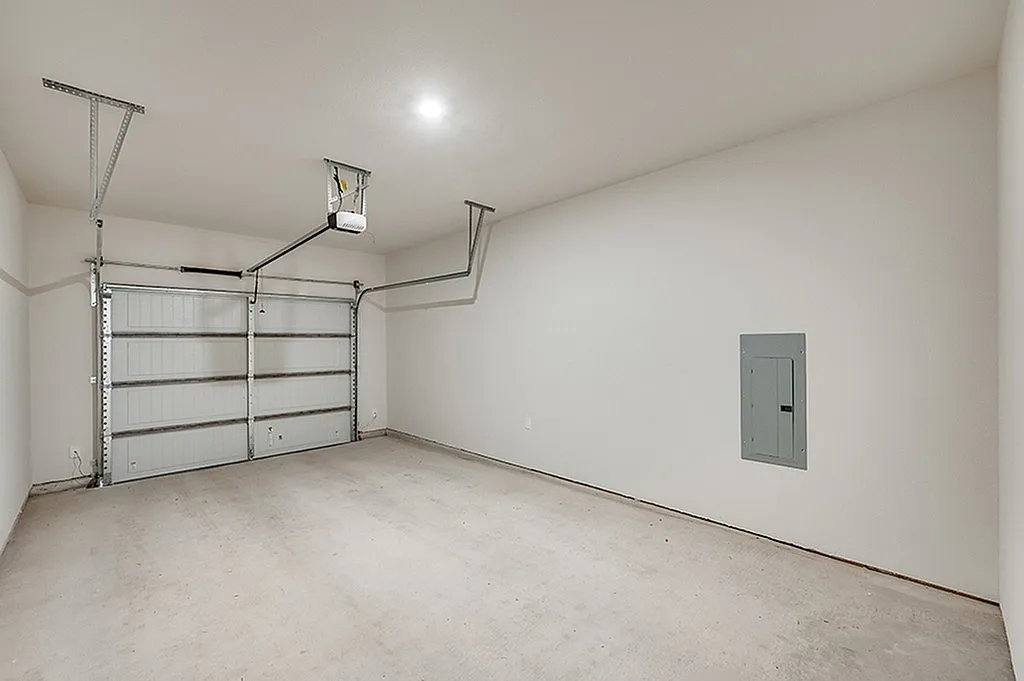 Luxe of Prosper | Apartments in McKinney | Rental in McKinney | Spacious, clean garage with smooth flooring and modern garage door, perfect for secure parking or storage.