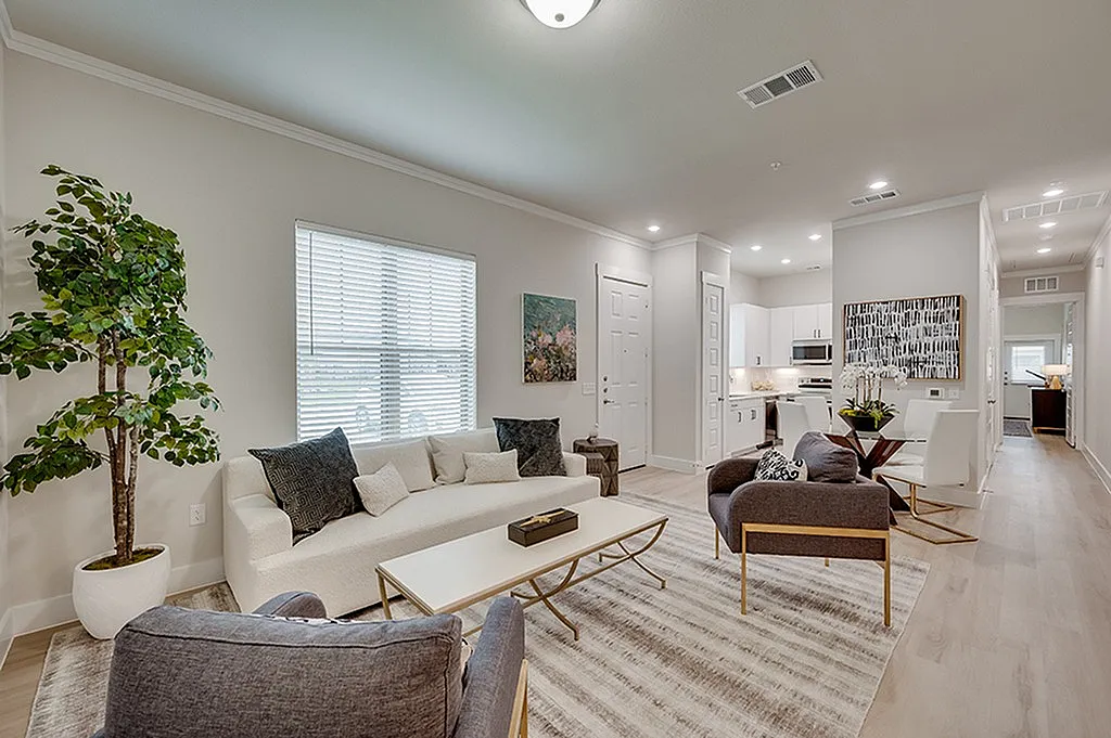 Luxe of Prosper | Apartments in McKinney | Rental in McKinney | Elegant open-plan apartment living room, cozy seating area, and bright kitchen.