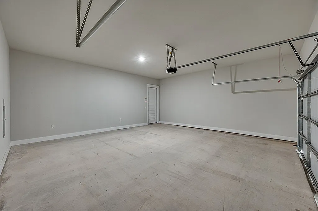 Luxe of Prosper | Apartments in McKinney | Rental in McKinney | Spacious and modern two-car garage with pristine walls and ample lighting, ideal for storage and parking.