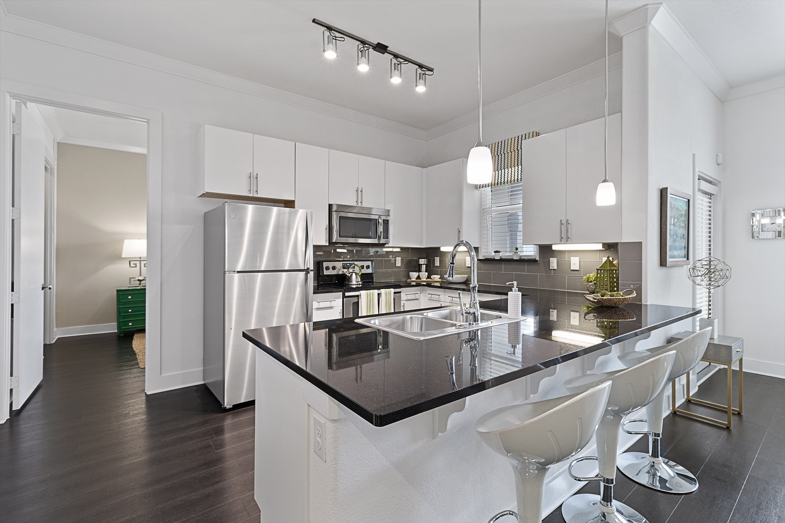 Modern kitchen with sleek appliances, elegant pendant lighting, and a spacious island for entertaining.