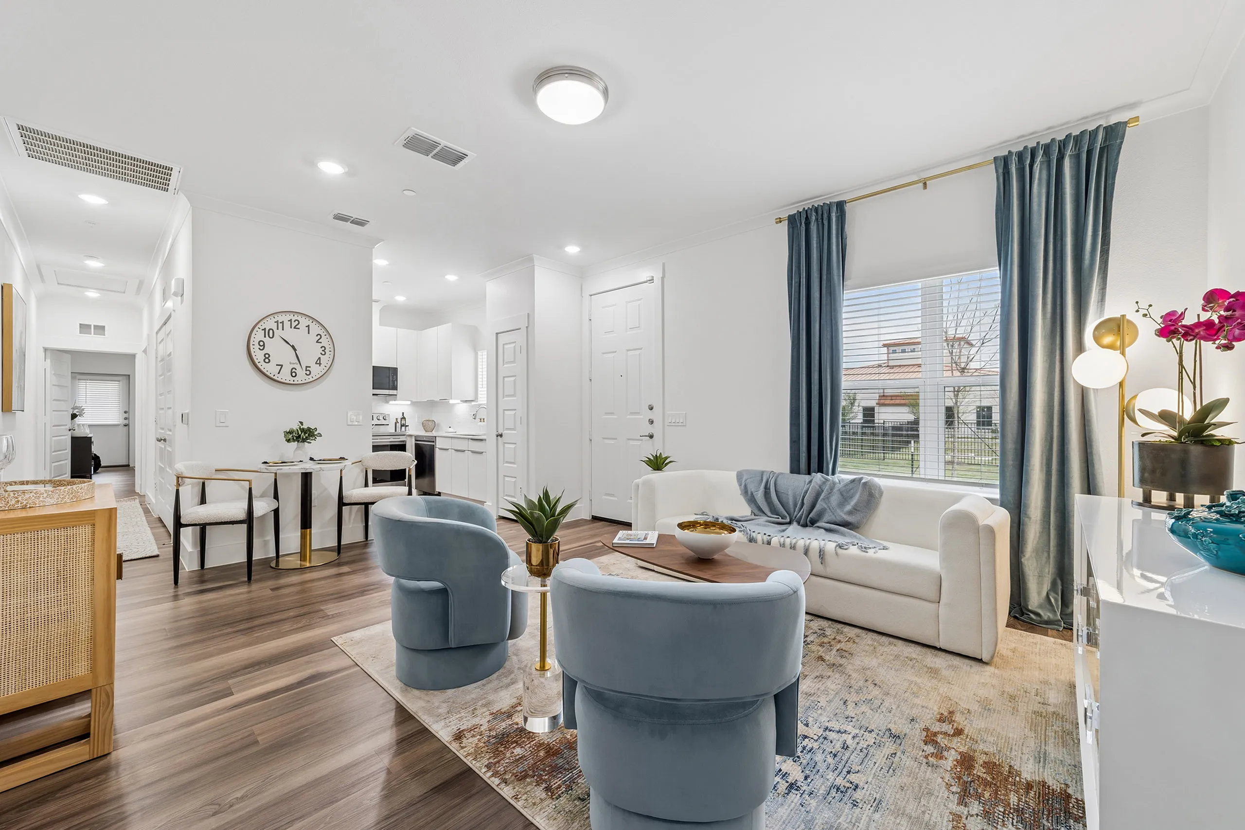 Contemporary open-plan living room with elegant furniture, modern decor, and bright natural light.