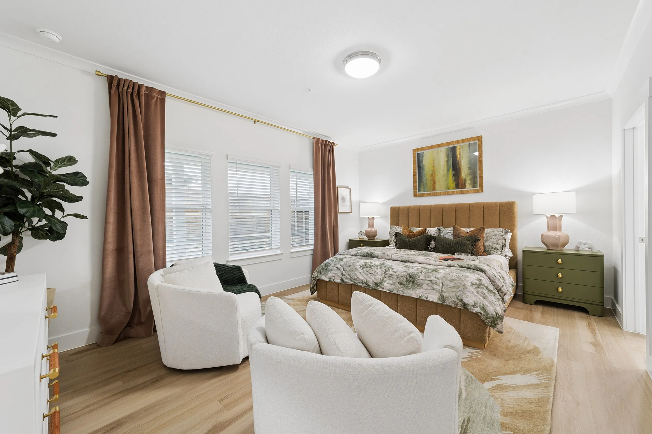 Elegant bedroom with a luxurious king-sized bed, stylish decor, and cozy seating area, featuring soft natural light and inviting ambiance.
