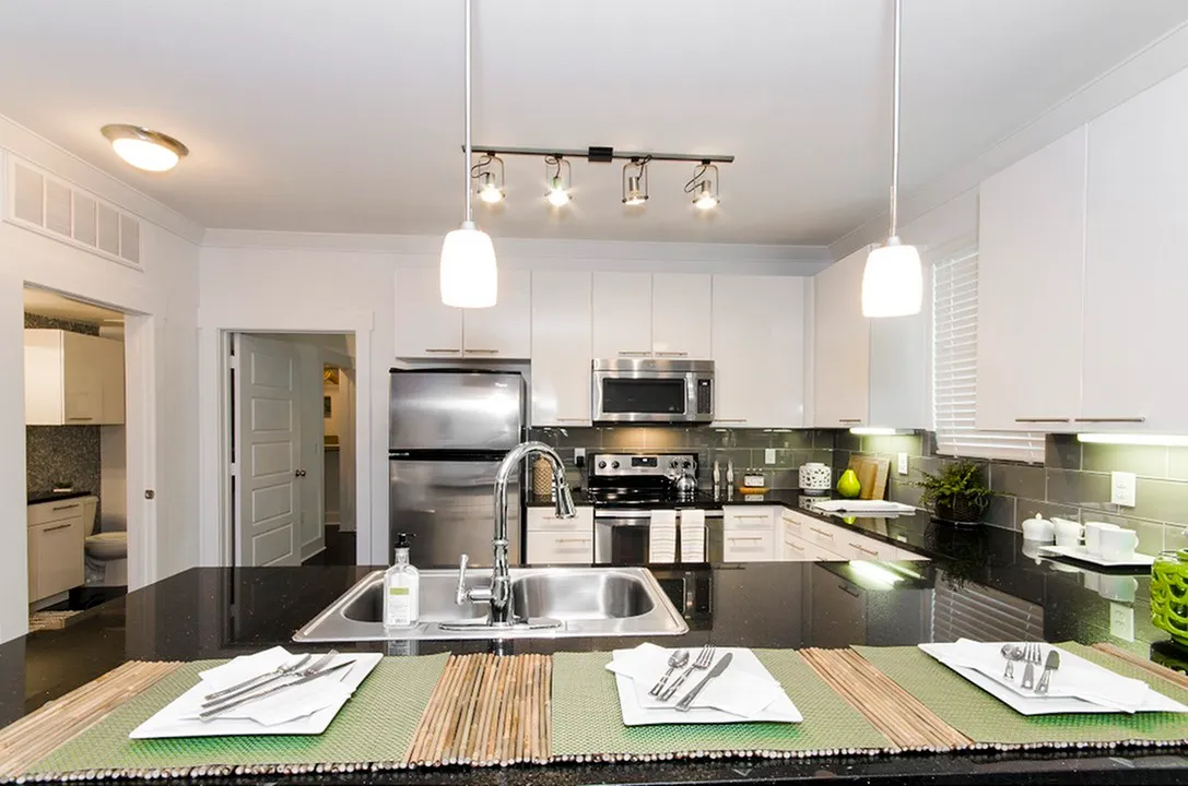 Sleek modern kitchen with stainless steel appliances and elegant lighting.