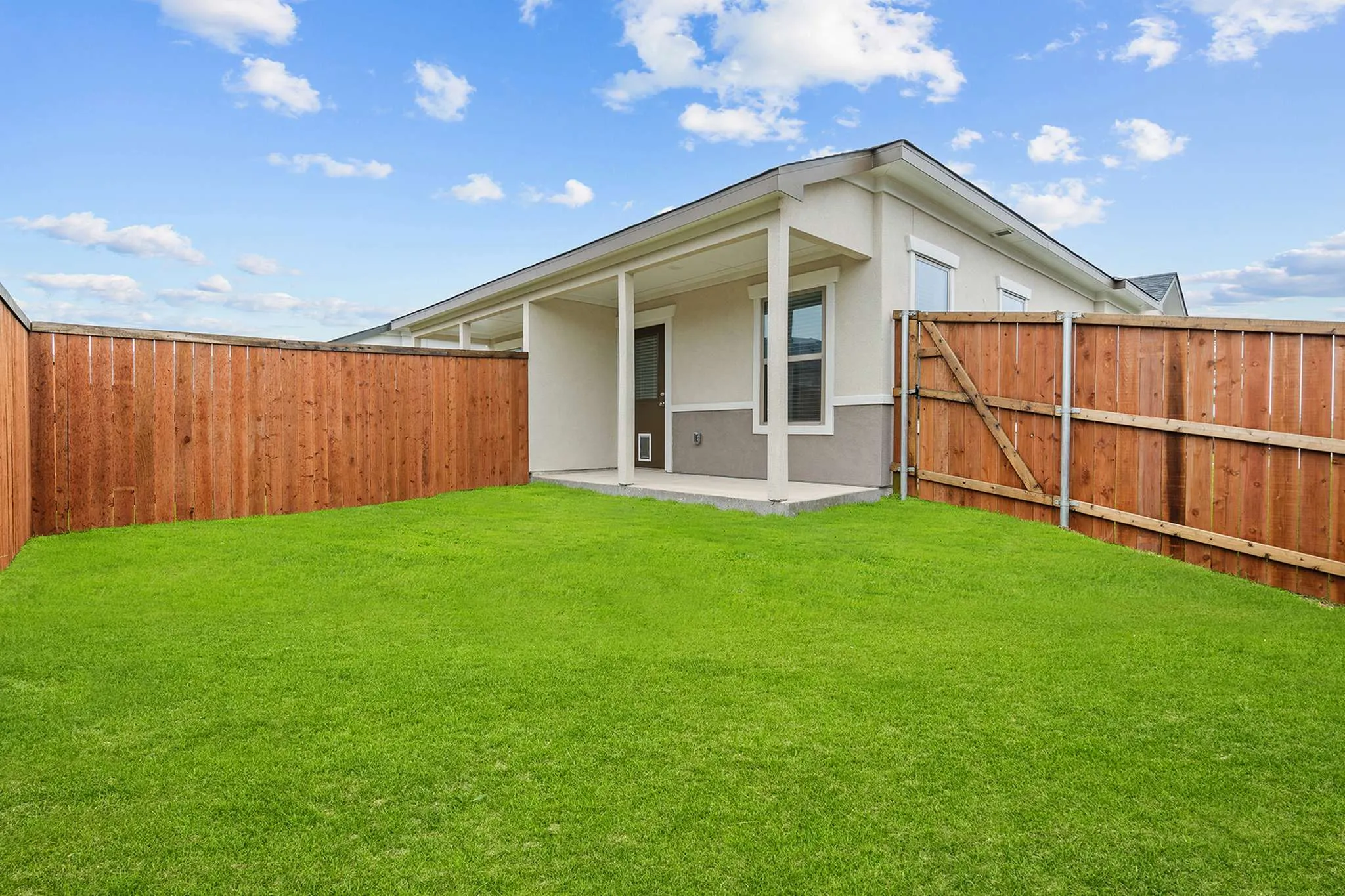 Fenced backyard with covered patio | Apartments in Hutto, TX | Mansions Eight65